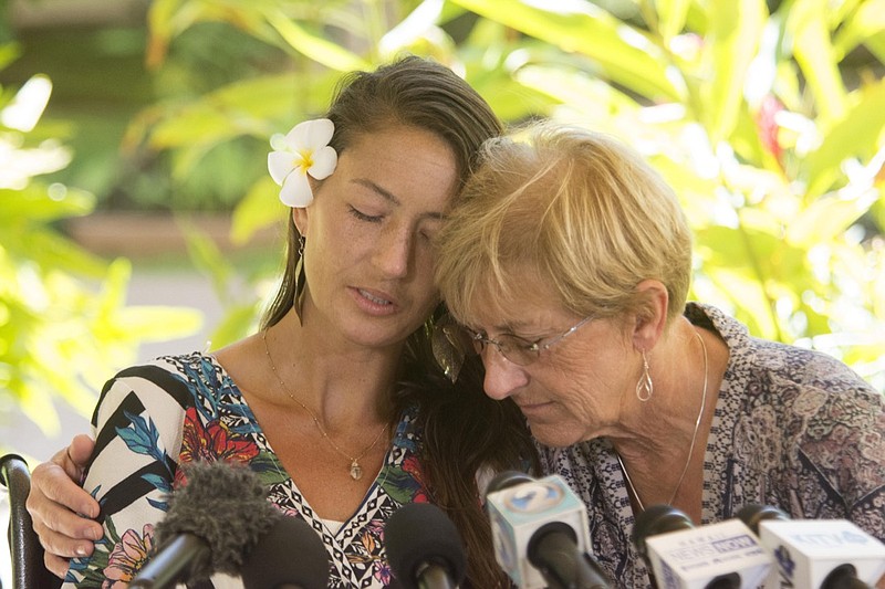 Rescued hiker Amanda Eller, left, has a moment with her mother, Julia Eller, before a press conference begins at Maui Memorial Hospital, Tuesday, May 28, 2019, in Wailuku, Hawaii. Eller said she fell to the ground and started bawling when a rescue helicopter spotted her in a forest where she had survived for two weeks by eating plants and drinking stream water. Eller says she set out for a 3-mile hike in the Makawao Forest Reserve on May 8. (Craig T. Kojima/Honolulu Star-Advertiser via AP)
