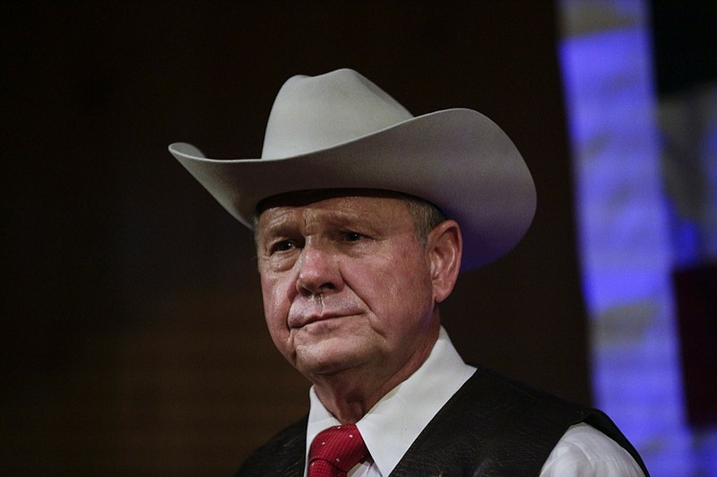 FILE - In this Sept. 25, 2017, file photo, Roy Moore speaks at a rally in Fairhope, Ala. President Donald Trump is warning that the consequences will be devastating if failed Alabama Republican Roy Moore runs again for a senate seat in 2020. Moore lost in the once-reliably red state in a 2017 special election amid sexual misconduct allegations which he denied. (AP Photo/Brynn Anderson, File)

