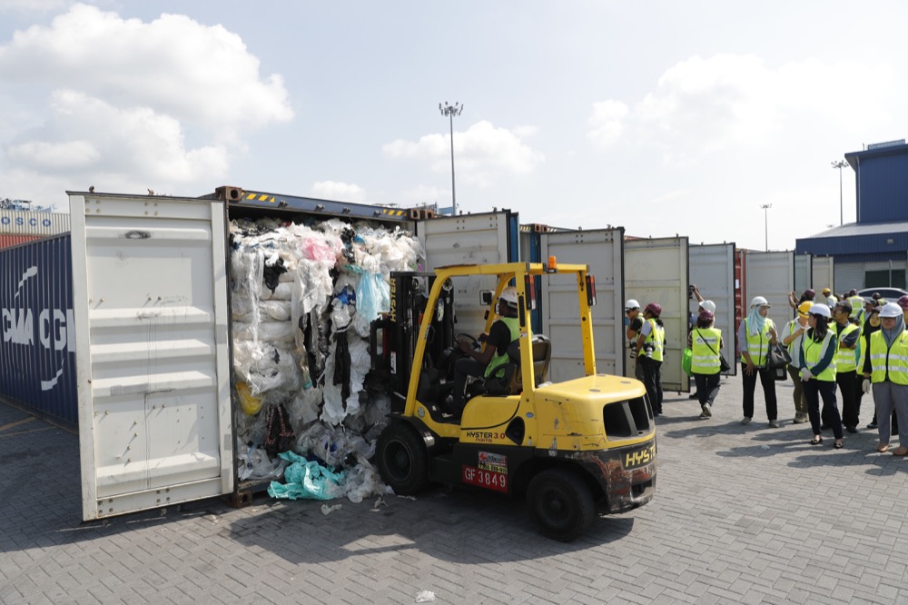 Officers from ministry of environment examining a container with full of non-recyclable plastic scraps from China which detained by authority's at westport in Klang, Malaysia, Tuesday, May 28, 2019. Malaysia environment minister Yeo Bee Yin says Malaysia has become a dumping ground for the world's plastic waste, and Malaysia has begun sending non-recyclable plastic scrap to the developed countries of origin.(AP Photo/Vincent Thian)