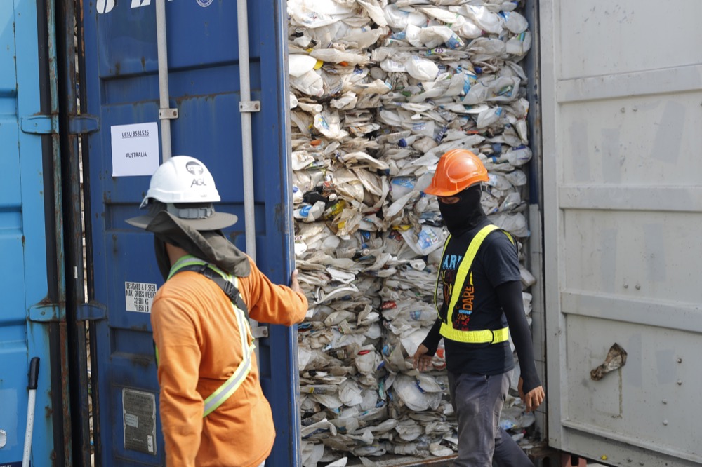 Workers opening a container with full of non-recyclable plastic scraps which detained by authority's at westport in Klang, Malaysia, Tuesday, May 28, 2019. Malaysia environment minister Yeo Bee Yin says Malaysia has become a dumping ground for the world's plastic waste, and Malaysia has begun sending non-recyclable plastic scrap to the developed countries of origin.(AP Photo/Vincent Thian)