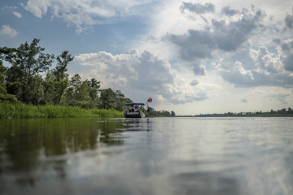 In this undated image released by SEARCH Inc., archaeological survey teams work to locate the slave ship Clotilda, in delta waters north of Mobile Bay, Ala. Remains of the Gulf schooner Clotilda were identified and verified near Mobile after months of assessment, a statement by the Alabama Historical Commission said. (Daniel Fiore/SEARCH, Inc. via AP)