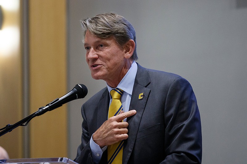 University of Tennessee President Randy Boyd points to his "C" lapel pin as he speaks during the Tennessee Valley Corridor Summit on the campus of the University of Tennessee at Chattanooga on Thursday, May 30, 2019, in Chattanooga, Tenn. Tennessee Gov. Bill Lee gave the keynote address to the summit.