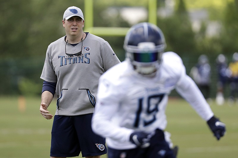 Tennessee Titans offensive coordinator Arthur Smith, left, watches wide receiver Tajae Sharpe during offseason drills May 21 in Nashville. Smith is preparing for his first season in the role, though this will be his ninth season with the Titans.