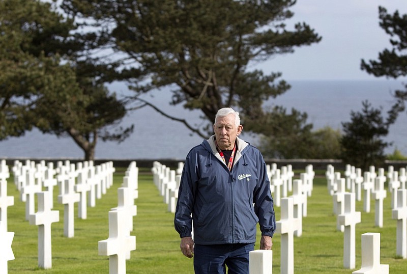 In this May 2, 2019, photo, Vietnam veteran Tom Woolbright from Fort Worth, Texas, walks among the headstones at the American military cemetery in Colleville-sur-Mer, France. This bonds us, and a war like that should never happen again, Woolbright said. (AP Photo/Virginia Mayo)