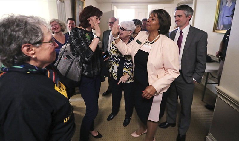 State Sen. Melanie Levesque, D-Hillsborough, right, is congratulated following a vote on the death penalty at the State House in Concord, N.H., Thursday, May 30, 2019. New Hampshire, which hasn't executed anyone in 80 years and has only one inmate on death row, on Thursday became the latest state to abolish the death penalty when the state Senate voted to override the governor's veto. (AP Photo/Charles Krupa)

