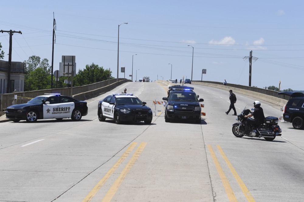 Fort Smith police block off the Garrison Ave. bridge in Fort Smith, Ark., as the Arkansas River floods parts of downtown Fort Smith Thursday, May 30, 2019. (AP Photo/Michael Woods)
