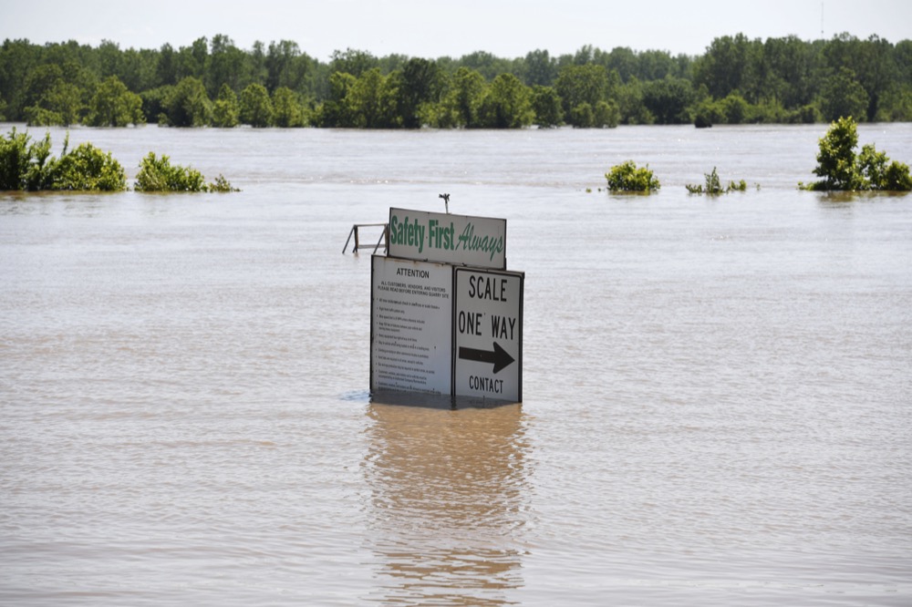 The Arkansas River floods along Adams Street Thursday, May 30, 2019, in Van Buren, Ark. (AP Photo/Michael Woods)