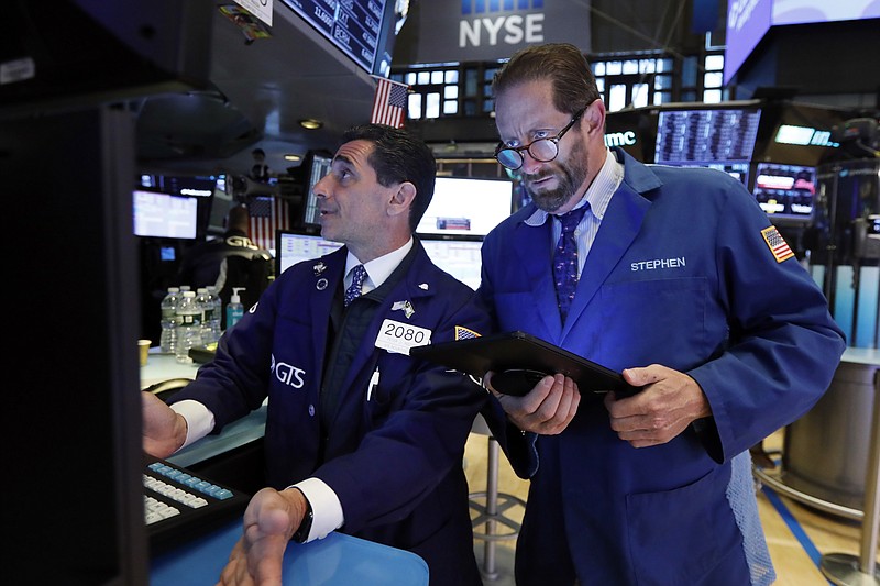 FILE - In this May 28, 2019, file photo specialist Peter Mazza, left, and trader Stephen Gilmartin work on the floor of the New York Stock Exchange. The U.S. stock market opens at 9:30 a.m. EDT on Friday, May 31. (AP Photo/Richard Drew, File)