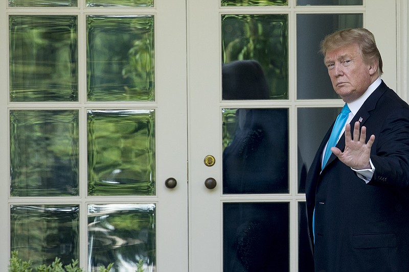 President Donald Trump waves as he walks towards the Oval Office in Washington recently. (AP Photo/Andrew Harnik)