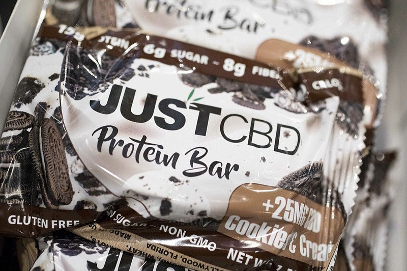A cookies and cream flavored protein bar marketed by JustCBD is displayed at the Cannabis World Congress & Business Exposition trade show, Thursday, May 30, 2019 in New York. (AP Photo/Mark Lennihan)

