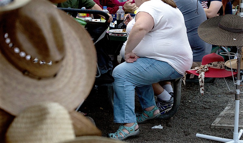 FILE ѠOverweight people at the Evergreen State Fair in Monroe, Wash., Sept. 9, 2015. Over the past 10 years, short-term disability claims for joint disorders have increased 38%, and long term disability claims for joint disorders are up 57%. Greg Breter, senior vice president of Benefits at Unum, said the rising rate of obesity is the primary driver in the growing number of claims. One in three Tennesseans are considered obese, according to the CDC.  (Ruth Fremson/The New York Times) 