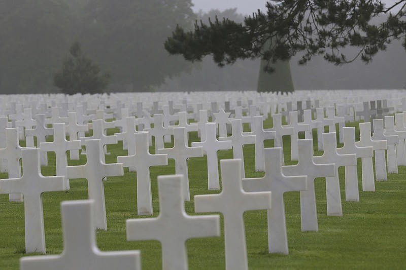 In this June 6, 2018, file photo, headstones at the Colleville American military cemetery, in Colleville sur Mer, western France. The world will turn its eyes to the beaches of France to mark the 75th anniversary of the D-Day. The United States representative at the solemn ceremony in Normandy will be President Donald Trump, whose complicated relationship with the armed forces includes allegations of draft dodging, feuds with Gold Star families and considerations of pardoning soldiers accused of war crimes. (AP Photo/David Vincent, File)