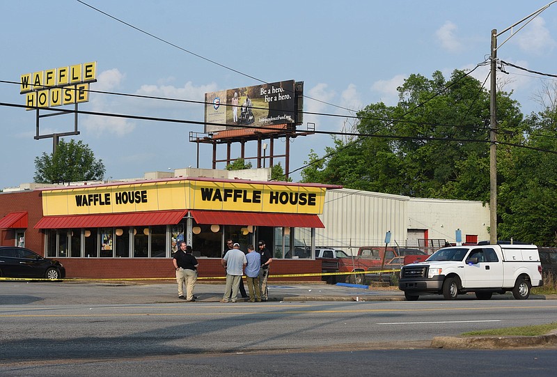 Staff photo by Tim Barber / Shortly after 8 a.m., Chattanooga police are on the scene of a 4 a.m. shooting at the Waffle House on East 23rd Street that left an officer wounded but in stable condition. Another person on the scene was shot, according to early news reports.