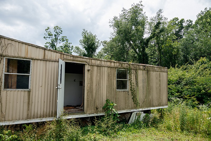 The door of an abandoned trailer in the Stoney Pointe Mobile Home Park swings in the wind on Thursday, May 30, 2019, in Rossville, Ga. A new Georgia law that allows land owners to move or buy homes that sit on their property, which is supposed to help solve the problem of abandoned manufactured homes, went into effect May 1.