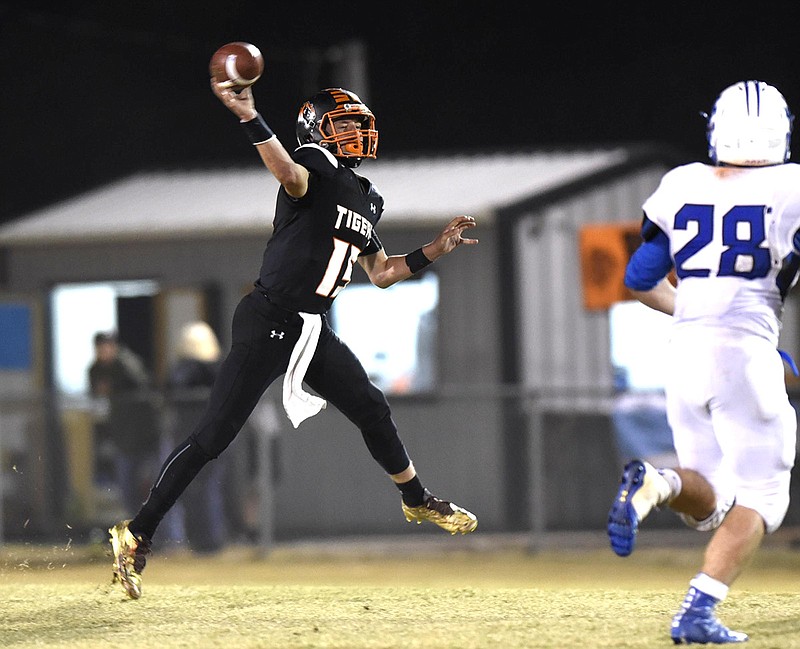 Meigs County quarterback Aaron Swafford (19) throws a pass on the run.  The Jackson County Blue Devils visited the Meigs County Tigers in the first round of the TSSAA playoff on November 4, 2016.