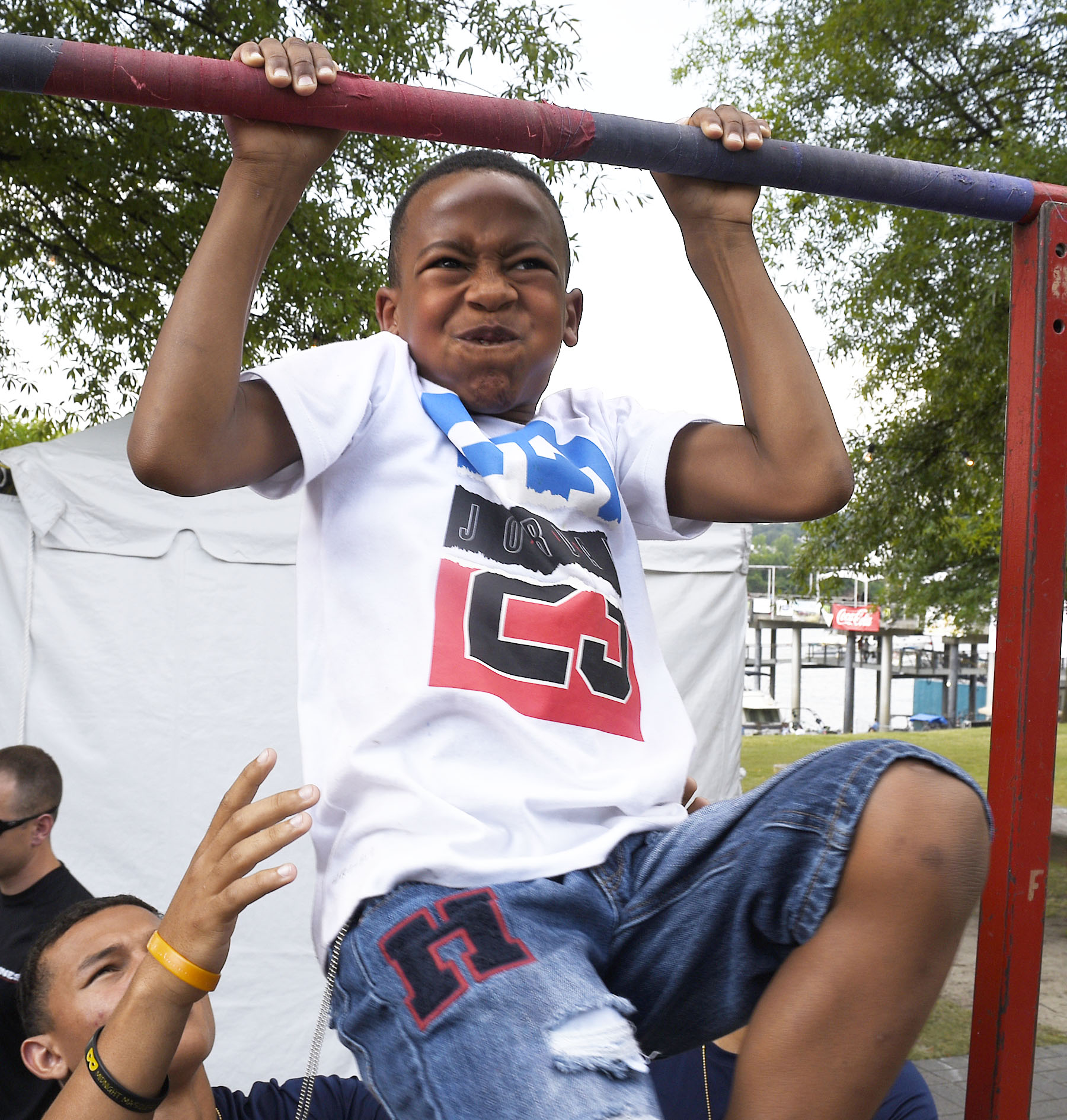 With the help of some Marines Michael Massey Jr. of Atlanta completes another chin-up.