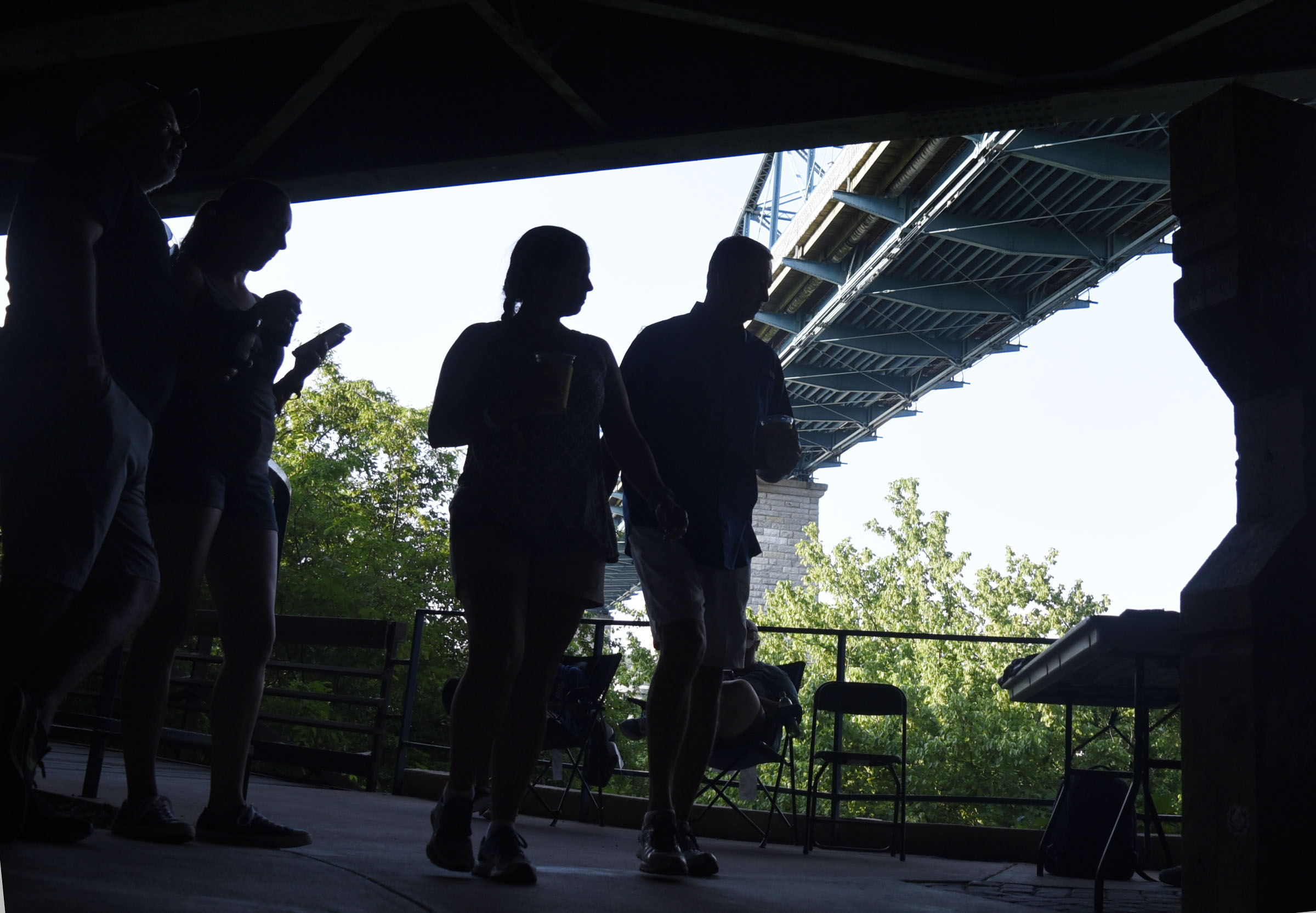 Riverbend patrons pass as silhouettes below Riverfront Parkway near the TVFCU Stage.  Macklemore was the featured act on the final night of the 2019 Riverbend Festival on June 1, 2019.