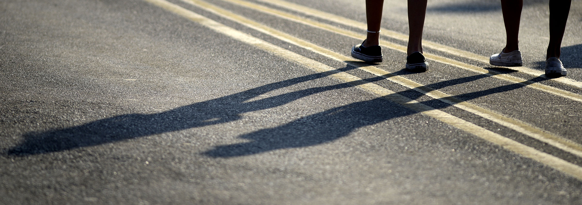 Shadows follow their owners on Riverfront Parkway at the Riverbend site.