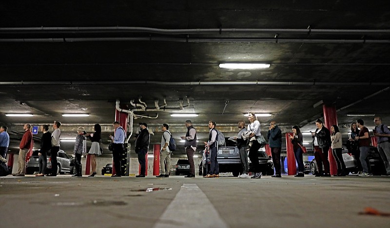 FILE - In this Tuesday, Nov. 6, 2018, file photo, a line backs up into a parking garage outside a polling site on Election Day in Atlanta. In Georgia, where claims of voter suppression in the state s 2018 governor s race is the basis of a federal lawsuit, Republicans have passed measures relaxing some restrictions and requiring more notification before voters are removed from registration lists. (AP Photo/David Goldman, File)

