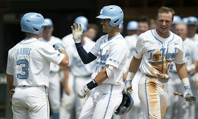 North Carolina's Dallas Tessar, center, celebrates with Dylan Harris after hitting a two-run home run in the second inning of an NCAA regional game against UNC Wilmington on Friday in Chapel Hill, N.C. North Carolina won 7-1, beat Liberty 16-1 on Saturday and beat Tennessee 5-2 on Sunday to win the regional and advance to this week's super regionals.