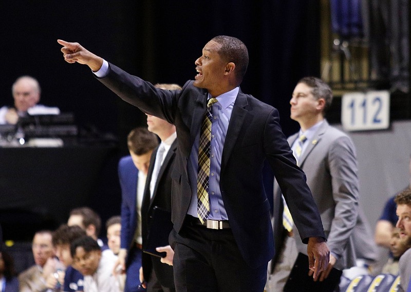 Chattanooga men's basketball coach Lamont Paris directs players during the Mocs' SoCon basketball game against the Furman Paladins at McKenzie Arena on Saturday, March 2, 2019, in Chattanooga, Tenn.