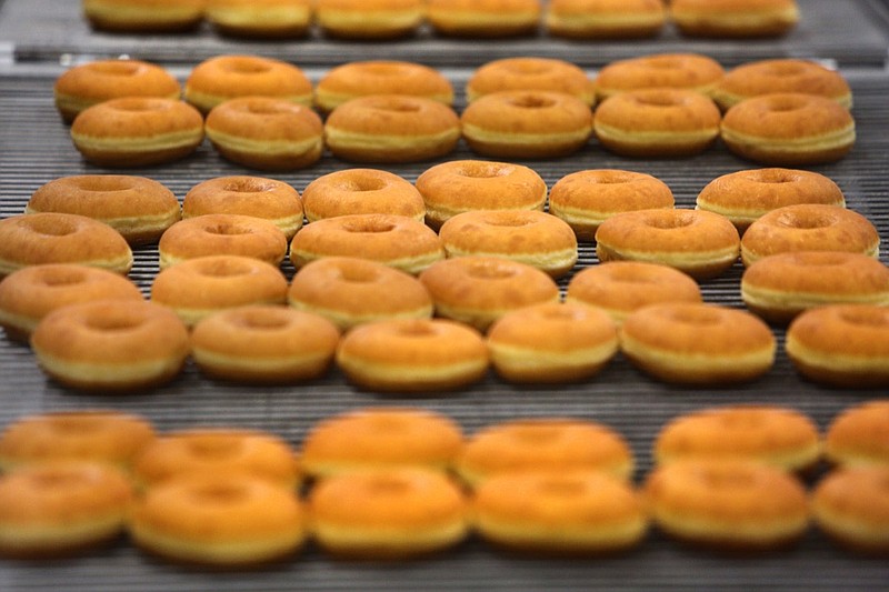 Doughnuts make their way down the production line Tuesday, April 17, 2018, at BMG Bakery in Ringgold, Ga