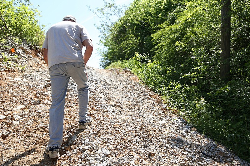 Eric Fleming treks back up a path put down for work along South Chickamauga Creek Wednesday, April 24, 2019 in Chattanooga, Tennessee. Fleming is trying to convince the city to leave a gravel road they put down for work along the creek, so individuals who want to get out on the creek will have easier access. 