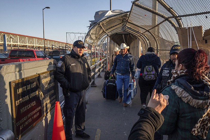 Border Patrol officers check travel documents on the Paso Del Norte Bridge, which connects El Paso, Texas, and Ciudad Juárez, Mexico, in March. President Donald Trump has called for imposing tariffs on Mexico, the administration's latest attempt to dissuade Central Americans from journeying north, while migrant families continue to arrive in unprecedented numbers. (Brett Gundlock/The New York Times)