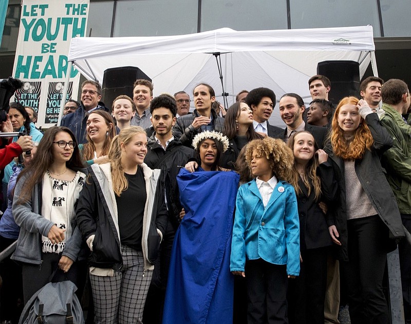 FILE - In this Oct. 29, 2018, file photo, young plaintiffs stand on the steps of the United States District Courthouse during a rally in Eugene, Ore., to support a high-profile climate change lawsuit against the federal government. A lawsuit by a group of young Americans accusing the U.S. government of harming them by having fostered a fossil-fuels energy system faces a major hurdle Tuesday, June 4, 2019, when a federal appeals court hears oral arguments on whether the case should proceed. (Andy Nelson/The Register-Guard via AP, File)

