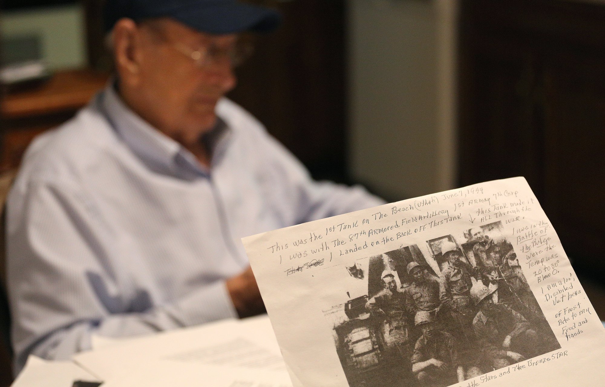 A younger Ralph Painter can be seen in the top right of a photo of his outfit that he pulled out during an interview Monday, October 15, 2018 at his home in East Brainerd, Tennessee. Painter fought in the Battle of the Bulge as well as D-Day.