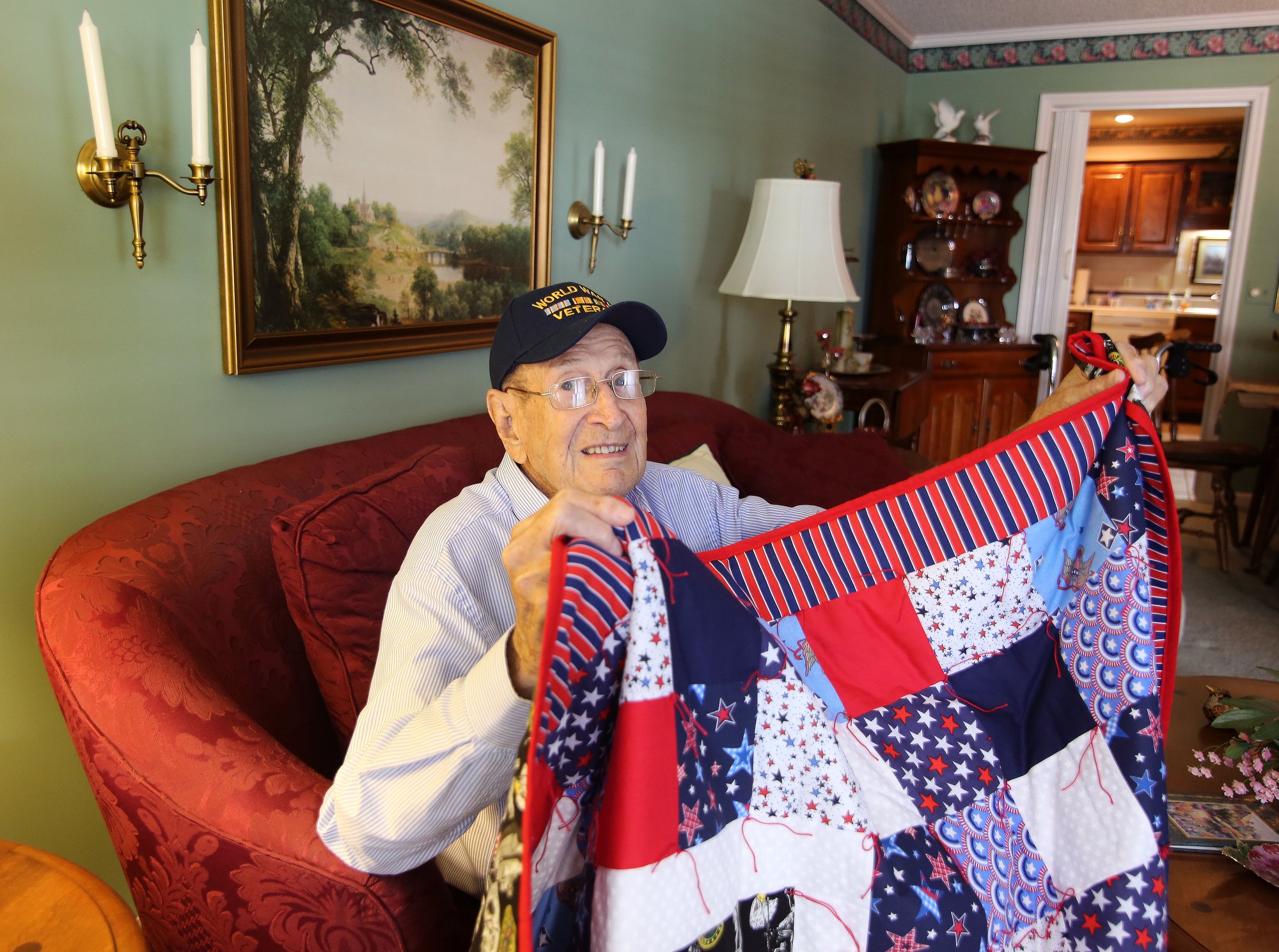 Ralph Painter shows off a blanket he was gifted for his service in World War II at his home in East Brainerd, Tennessee, Monday, October 15, 2018. Painter was a staff sergeant in the Battery B in the 87th Armored Field Artillery Battalion.