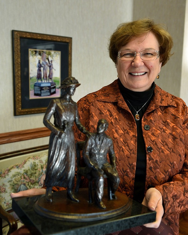Wanda Sobieski holds a model of the Burn Memorial that was erected at Clinch Avenue and Market Square in Knoxville to honor women's suffrage state tiebreaker Rep. Harry T. Burn and his mother, who had urged him to vote for suffrage in 1920. (Photo By Knoxville News Sentinel)