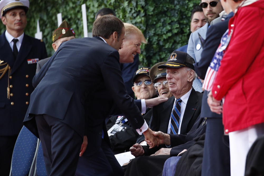 President Donald Trump and French President Emmanuel Macron greet veterans as they arrive to a ceremony to commemorate the 75th anniversary of D-Day at The Normandy American Cemetery, Thursday, June 6, 2019, in Colleville-sur-Mer, Normandy, France. (AP Photo/Alex Brandon)