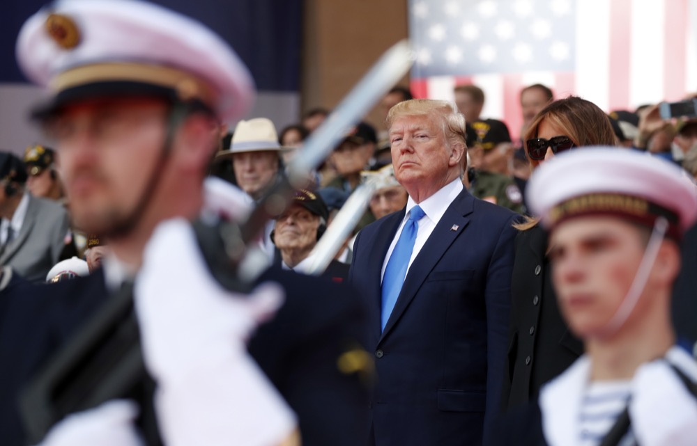 U.S. President Donald Trump and U.S First Lady Melania Trump attend a ceremony to mark the 75th anniversary of D-Day at the Normandy American Cemetery in Colleville-sur-Mer, Normandy, France, Thursday, June 6, 2019. World leaders are gathered Thursday in France to mark the 75th anniversary of the D-Day landings. (Ian Langsdon/POOL via AP)