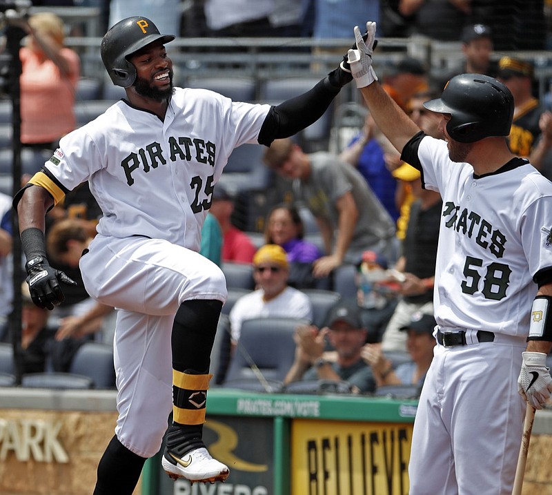 The Pittsburgh Pirates' Gregory Polanco, left, celebrates with Jacob Stallings as he returns to the dugout after hitting a solo home run off the Atlanta Braves' Mike Foltynewicz during the second inning of Thursday's game in Pittsburgh.