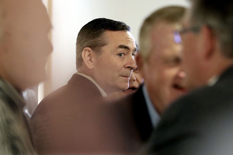 House Speaker Glen Casada, R-Franklin, center, talks with people before a meeting of the House Republican Caucus at a hotel Monday, May 20, 2019, in Nashville, Tenn. The caucus is meeting to discuss the future of Casada, who is ensnarled in a texting scandal. (AP Photo/Mark Humphrey)