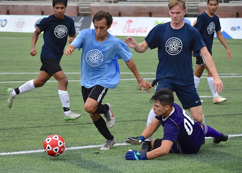 Former Coahulla Creek standout Panchito Medina, center, goes for the ball while playing for Georgia against Tennessee on Saturday at Finley Stadium during an all-star soccer game featuring recent area high school standouts.