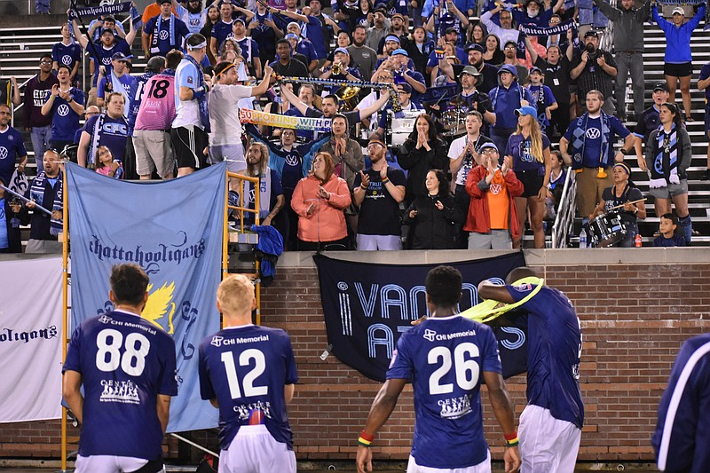 Chattanooga Football Club players celebrate with the Chattahooligans after a 4-0 triumph against Inter Nashville on Saturday night at Finley Stadium.