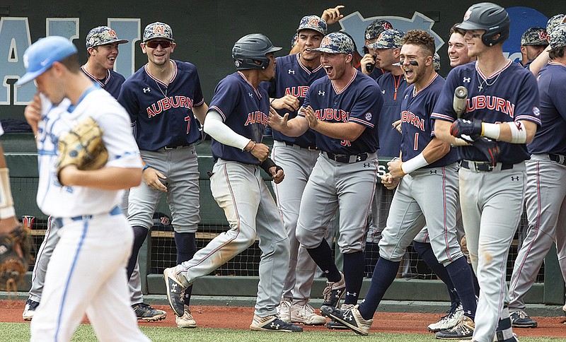 Auburn baseball players celebrate after taking the lead against North Carolina during the opener of a best-of-three NCAA super regional series Saturday in Chapel Hill, N.C.