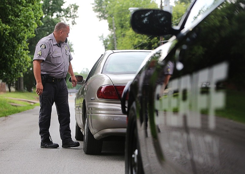 Staff photo by Erin O. Smith / 
Sgt. Kevin Denny with the Walker County Sheriff's Office speaks with an individual pulled over for a minor violation Friday, June 22, 2018 in Walker County, Georgia. The new hands free law will go into effect in Georgia on July 1. 