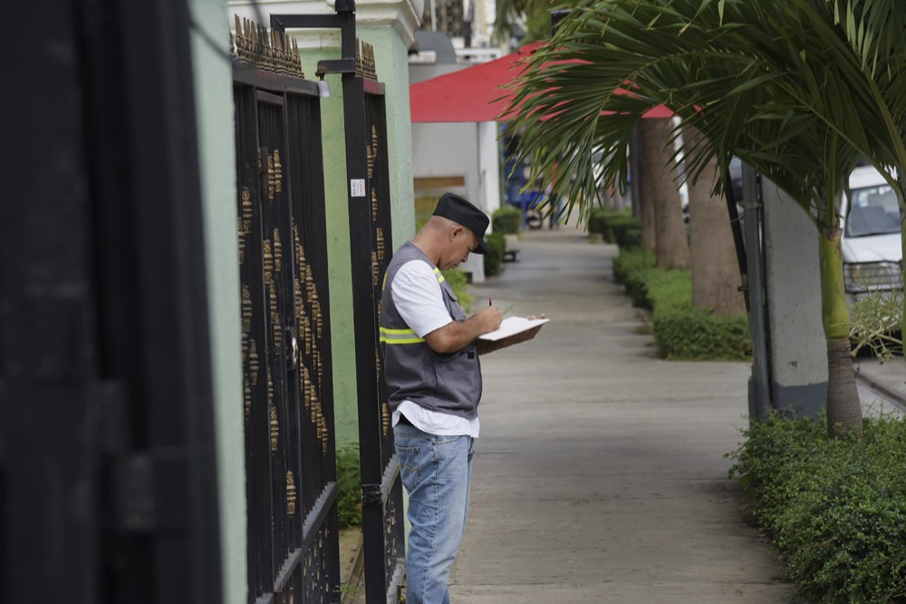 A member of the investigative police collects evidence in the area front of the "Dial Bar Anda Lounge" place doinde kla Sunday night the former Boston Red Sox star David Ortiz was shot in Santo Domingo, Dominican Republic, Monday, June 10, 2019. (AP Photo / Luis Gomez)