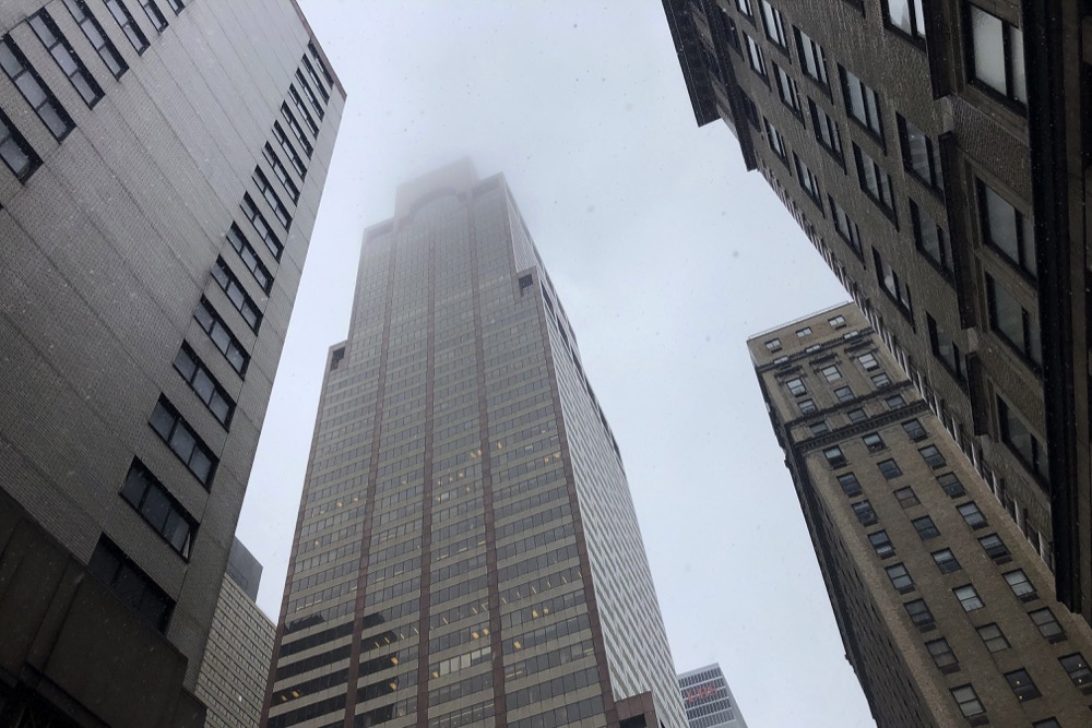 Mist and smoke cover the top of the building at 787 7th Ave., Monday, June 10, 2019, in New York, where a helicopter was reported to have crash landed on top of the roof of the building in midtown Manhattan. The FDNY said at around 2 p.m. that it had no further details of the incident, roughly located around 51st Street and Seventh Avenue. (AP Photo/Mark Lennihan)
