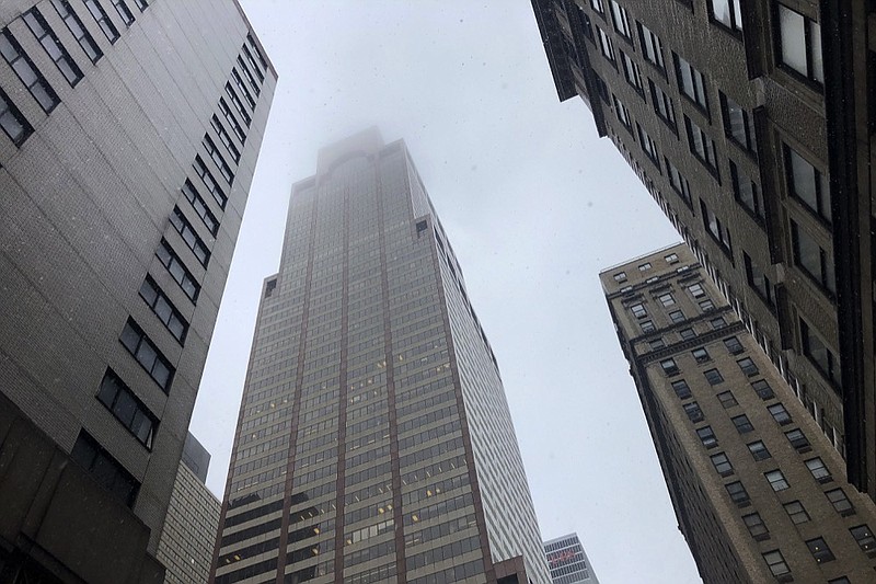 Mist and smoke cover the top of the building at 787 7th Ave., Monday, June 10, 2019, in New York, where a helicopter was reported to have crash landed on top of the roof of the building in midtown Manhattan. The FDNY said at around 2 p.m. that it had no further details of the incident, roughly located around 51st Street and Seventh Avenue. (AP Photo/Mark Lennihan) 