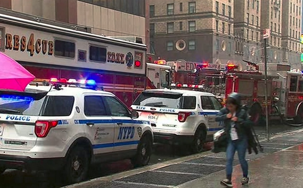 In this photo taken from video, first responders react to a scene near 52nd Street and 7th Ave., Monday, June 10, 2019, in New York, where a helicopter was reported to have crash landed on top of a building in midtown Manhattan. The FDNY said at around 2 p.m. Monday that it had no further details of the incident, roughly located around 51st Street and Seventh Avenue. (WABC via AP)
