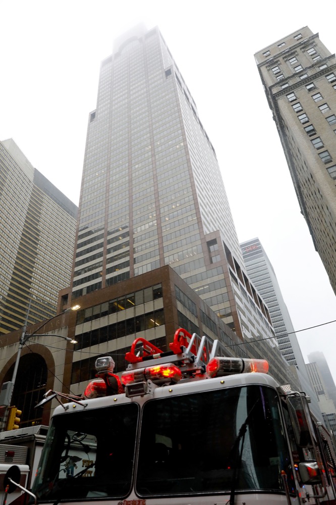 New York firefighters respond to the scene near 52nd Street and 7th Ave., Monday, June 10, 2019, in New York, where a helicopter was reported to have crash landed on top of a building in midtown Manhattan. The FDNY said at around 2 p.m. Monday that it had no further details of the incident, roughly located around 51st Street and Seventh Avenue. (AP Photo/Mark Lennihan)
