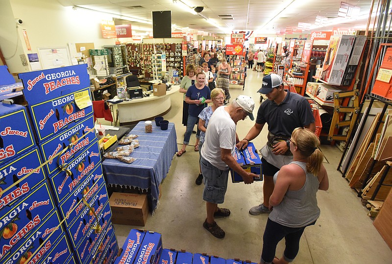 A long line of customers waits to pick up peaches at East Ridge Hardware at a previous visit by The Peach Truck. The store at 5337 Ringgold Road will be the second Chattanooga-area stop for fresh-picked deliveries on Saturday, scheduled from 11 a.m. to noon.