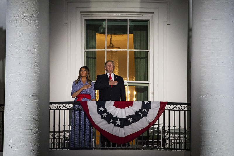 President Donald Trump and first lady Melania Trump during the national anthem before the start of Independence Day fireworks at the White House in Washington, on July 4, 2018. (Samuel Corum/The New York Times)