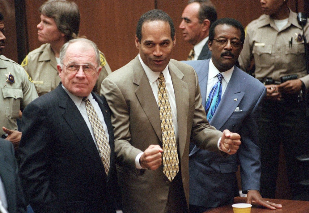 FILE - In this Oct. 3, 1995, file photo, O.J. Simpson reacts as he is found not guilty in the death of his ex-wife Nicole Brown Simpson and her friend Ron Goldman in Los Angeles. Defense attorneys F. Lee Bailey, left, and Johnnie L. Cochran Jr. stand with him. Cochran, Simpson's flamboyant lead attorney, died of brain cancer in 2005 at 68. His refrain to jurors that