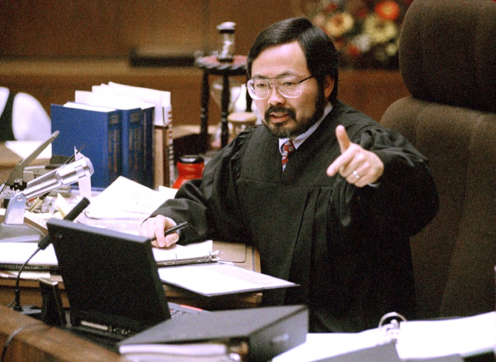 TIME FOR MOVEMENT AT 1 AM EDT MONDAY, JUNE 12 FILE - In this Feb. 12, 1995 file photo, Judge Lance Ito gives instructions to the jury before all parties in the O.J. Simpson double murder trial depart on a tour of four prominent Brentwood sites in Los Angeles. Ito, who retired in 2015, presided over approximately 500 trials after the one that made him such a household name that "The Tonight Show" briefly featured a comedy segment called "The Dancing Itos," in which Ito lookalikes in judicial robes performed. After the Simpson trial he had to remove his name plate from his courtroom door because people kept stealing it. Ito has never discussed the trial, citing judicial ethics. (AP Photo/Pool/Reed Saxon, File)