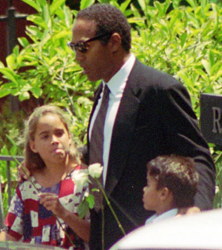TIME FOR MOVEMENT AT 1 AM EDT MONDAY, JUNE 12 FILE - In this June 16, 1994 file photo, O.J. Simpson, center, daughter Sydney and son Justin arrive at a private funeral for his ex-wife Nicole Brown Simpson in the Brentwood section of Los Angeles. Simpson would later be charged with the murder of Nicole and her friend Ronald Goldman and ultimately acquitted of criminal charges, but later convicted of civil liability in their deaths. (AP Photo/Eric Draper, File)